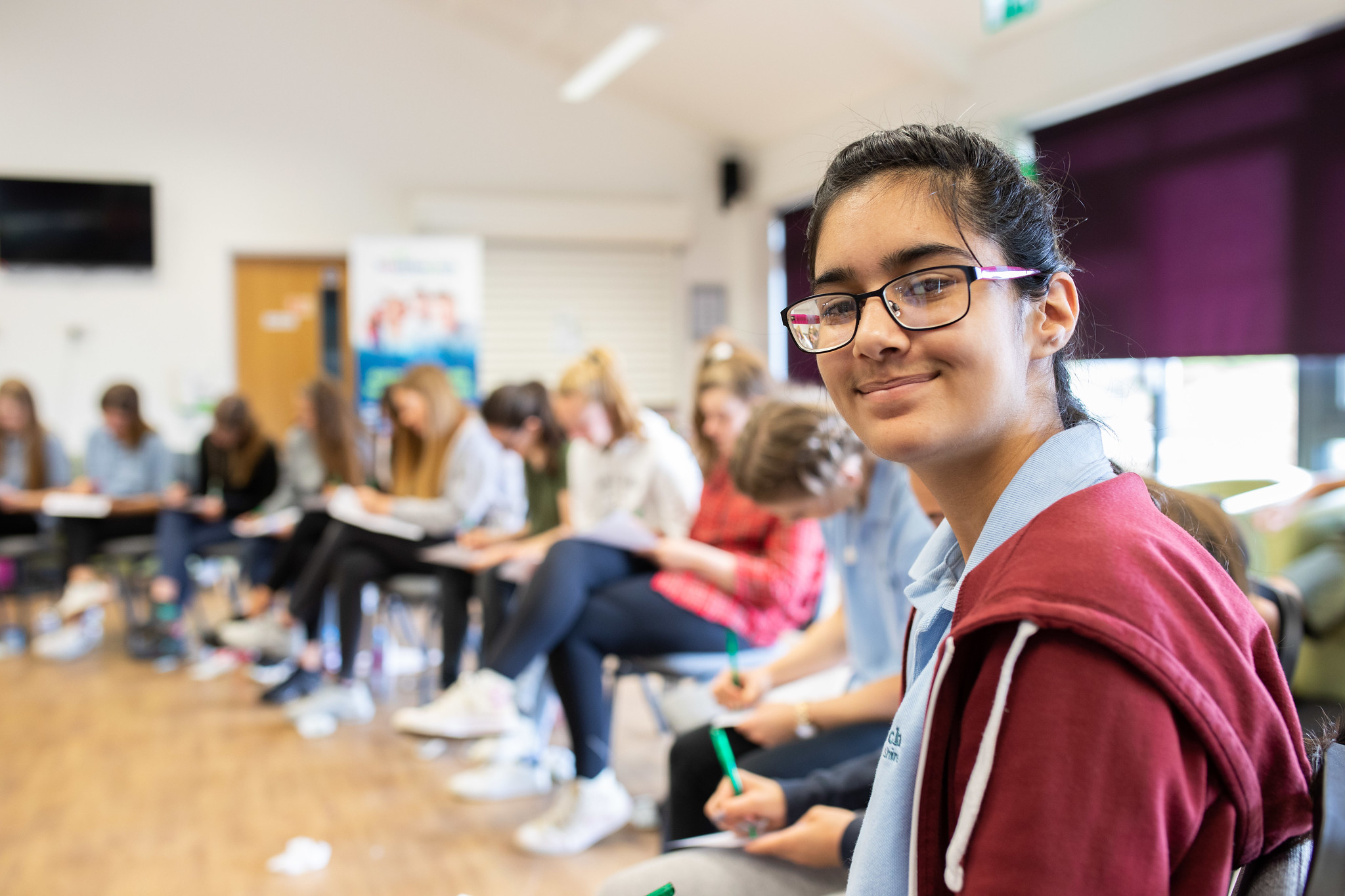 a teenage girl amongst a group of other teenagers