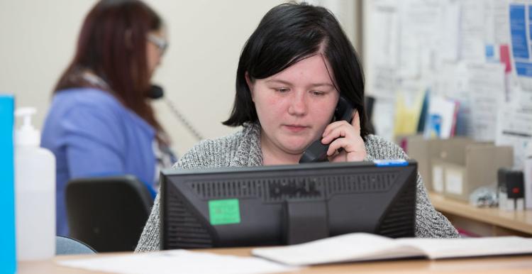 picture of woman with taking a call at reception 