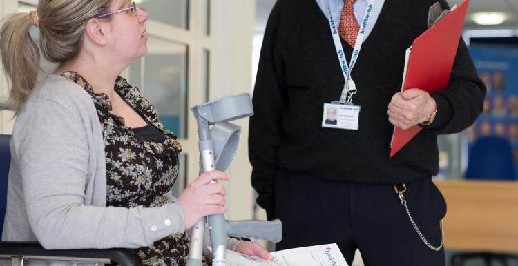 lady with a plastercast on her leg, holding crutches lady with a plastercast on her leg, holding crutches