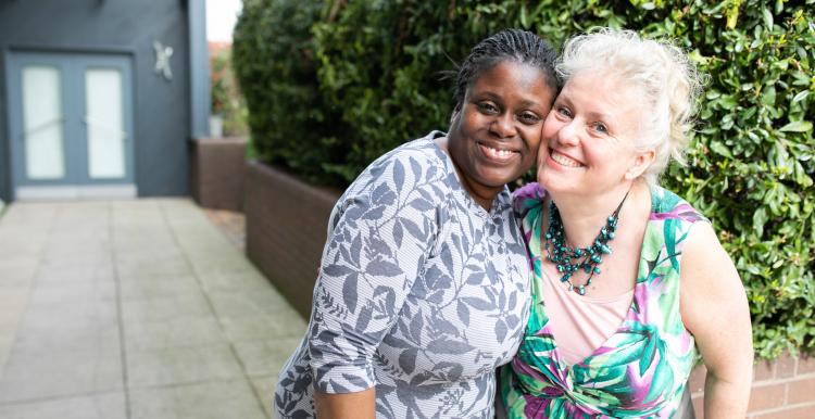 two ladies together laughing