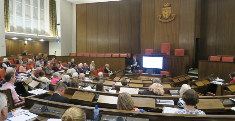 Chris Bain speaking to people in the Warwick council chamber