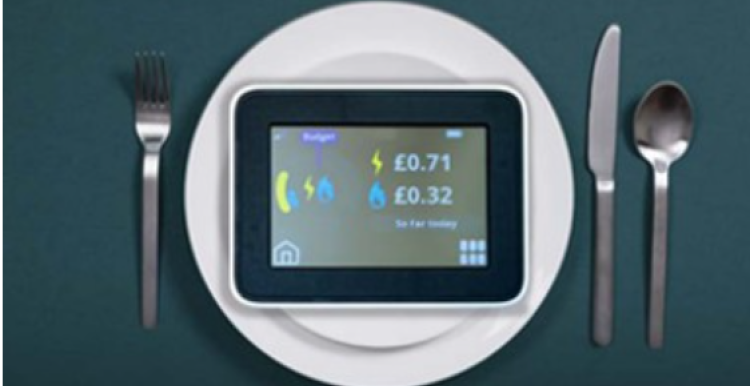 In home smart meter display on a plate next to cutlery