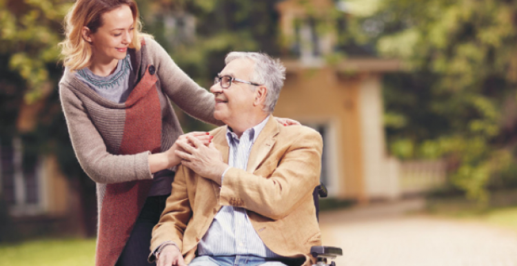 Lady with a man in a wheelchair