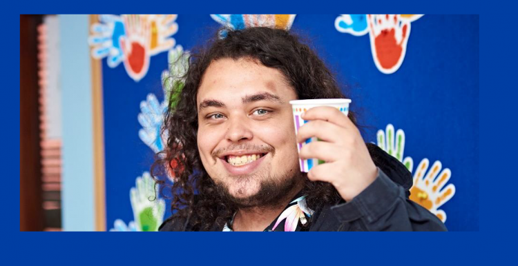 man smiling man smiling, drinking a hot drink