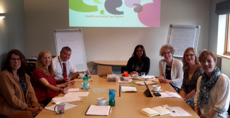 staff team sitting around a table