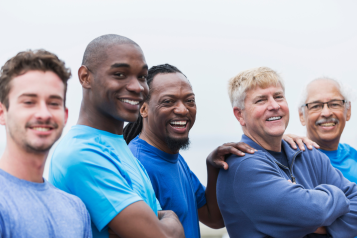 men smiling, wearing blue