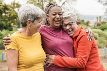 Three ladies hugging and smiling