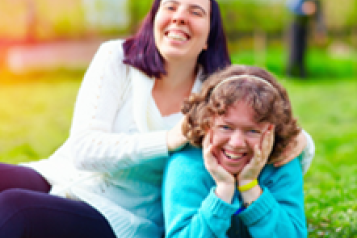 Two people laughing outside