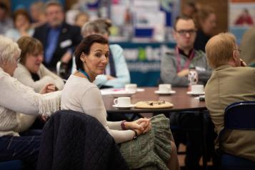 People sitting around a table at a conference