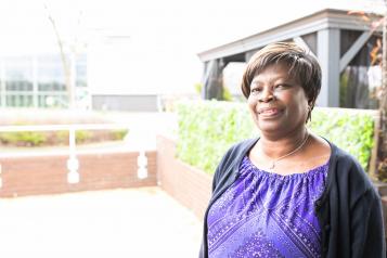 A photo of a lady standing outside a building