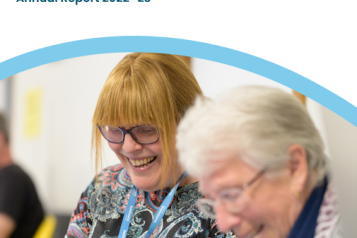 Two ladies laughing on front cover of our Annual Report