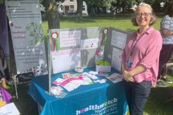 Staff member with our information stall
