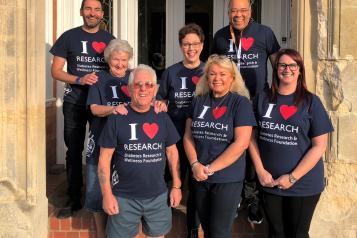 People standing in a group wearing T shirts with I love research diabetes research wellness foundation 