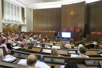 Chris Bain speaking to people in the Warwick council chamber