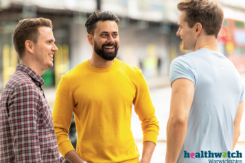 Three men chatting outside