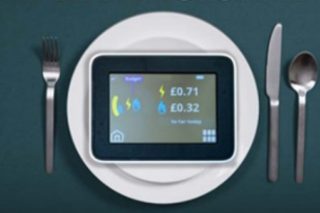 In home smart meter display on a plate next to cutlery