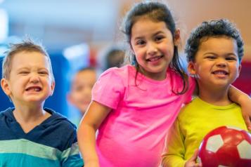 Three toddlers smiling