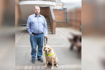 A man with a guide dog