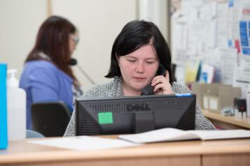 Receptionist on the phone at a GP surgery