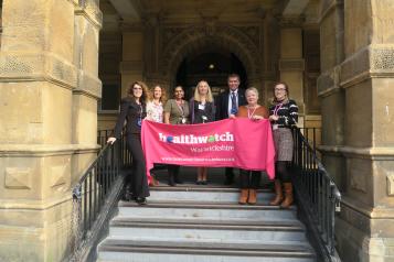 Staff team with Healthwatch Warwickshire banner
