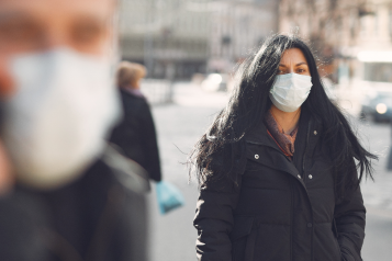 people in the street wearing masks