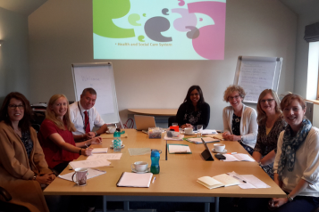 staff team sitting around a table