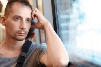 man looking out of a bus window