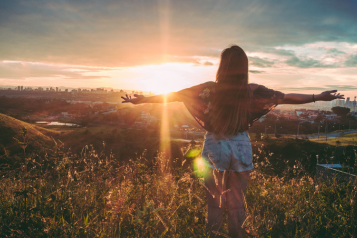 a lady watching the sunset