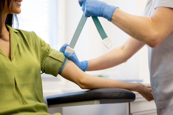 Nurse preparing patient for taking blood