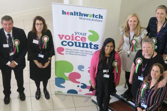 Healthwatch staff members with a banner Healthwatch staff members with a banner