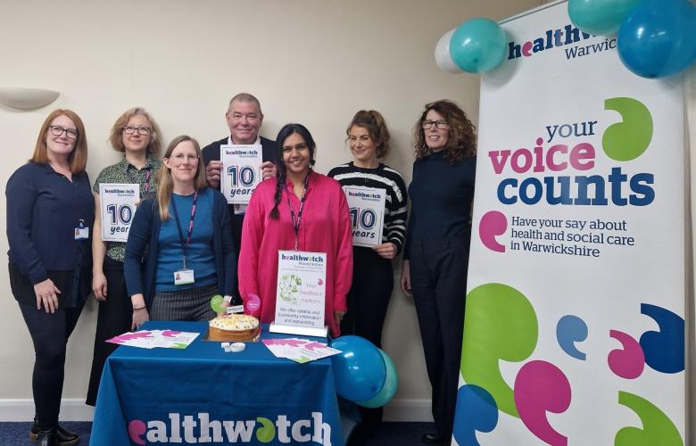 Healthwatch Warwickshire staff and 10 year anniversary display